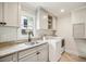 Bright laundry room with a window, white cabinets, granite counters and a washer and dryer at 4431 Skyland Ne Dr, Atlanta, GA 30342