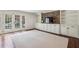 Bright living room features a brick accent wall, built-in shelving, and large french doors at 4431 Skyland Ne Dr, Atlanta, GA 30342