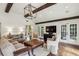 Comfortable living room showcasing beamed ceiling, hardwood floors, and ample natural light from surrounding windows at 4431 Skyland Ne Dr, Atlanta, GA 30342
