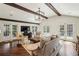 Bright living room with beamed ceilings, hardwood floors, and multiple french doors leading to the outdoors at 4431 Skyland Ne Dr, Atlanta, GA 30342