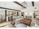 Open-concept living room with beamed ceilings and seamless flow into a gourmet kitchen and dining area at 4431 Skyland Ne Dr, Atlanta, GA 30342
