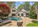 Backyard pool featuring lounge chairs on a stone patio, perfect for relaxation and entertaining at 4431 Skyland Ne Dr, Atlanta, GA 30342