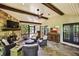 Inviting sunroom with stone fireplace, wood ceiling beams, and brick flooring, perfect for relaxation at 4431 Skyland Ne Dr, Atlanta, GA 30342