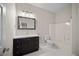 A well-lit bathroom offers a mosaic mirror, modern vanity and a shower-tub combo at 4866 Pinnacle Dr, Stone Mountain, GA 30088