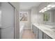 Bright bathroom featuring dual sinks, a shower-tub, and natural light at 4866 Pinnacle Dr, Stone Mountain, GA 30088