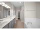 Bathroom with dual sinks, a soaking tub, and a separate shower at 4866 Pinnacle Dr, Stone Mountain, GA 30088