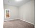 Bedroom features neutral walls, carpeted floors and window with wooded views at 4866 Pinnacle Dr, Stone Mountain, GA 30088