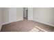 Bedroom features neutral walls, carpeted floors with view into bathroom at 4866 Pinnacle Dr, Stone Mountain, GA 30088