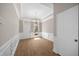 Grand entryway boasts elegant wainscoting, hardwood floors, and a tray ceiling with a chandelier at 4866 Pinnacle Dr, Stone Mountain, GA 30088
