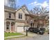 Charming townhome showcasing a brick and stone exterior, attached garage, and manicured front yard at 4866 Pinnacle Dr, Stone Mountain, GA 30088