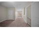 Carpeted hallway leading to bedrooms and stairway at 4866 Pinnacle Dr, Stone Mountain, GA 30088