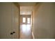 Bright hallway features laminate floors, and neutral walls and leads to a room with windows at 4866 Pinnacle Dr, Stone Mountain, GA 30088