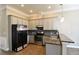 Modern kitchen featuring stainless steel appliances, granite countertops, and sleek gray cabinetry at 4866 Pinnacle Dr, Stone Mountain, GA 30088