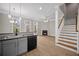 Modern kitchen with granite countertops, stainless steel appliances, gray cabinets, and an open view to the living area at 4866 Pinnacle Dr, Stone Mountain, GA 30088