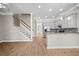 Spacious living area featuring hardwood floors, an open layout, adjacent kitchen, and a staircase at 4866 Pinnacle Dr, Stone Mountain, GA 30088