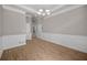 Bright living room featuring wood-look flooring, crown molding, and a classic chandelier at 4866 Pinnacle Dr, Stone Mountain, GA 30088