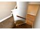 Carpeted stairway with wooden handrail leads to a bright landing with hardwood floors at 4866 Pinnacle Dr, Stone Mountain, GA 30088