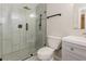 This bathroom has a glass shower, gray vanity, and modern fixtures at 8404 Park Ridge Ln, Riverdale, GA 30274