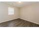 This bedroom features wood-look flooring and a window providing natural light at 8404 Park Ridge Ln, Riverdale, GA 30274