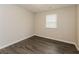 This bedroom features wood-look flooring and a window providing natural light at 8404 Park Ridge Ln, Riverdale, GA 30274