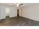This spacious bedroom features wood-look flooring, a ceiling fan, and an attached walk-in closet at 8404 Park Ridge Ln, Riverdale, GA 30274