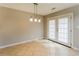 Bright dining area with tile flooring, modern lighting, and access to the outdoors at 8404 Park Ridge Ln, Riverdale, GA 30274