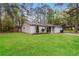 Well-manicured lawn highlights this lovely single-story home with a side view at 8404 Park Ridge Ln, Riverdale, GA 30274