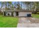Charming single-story home with a well-maintained lawn and a classic, neutral exterior at 8404 Park Ridge Ln, Riverdale, GA 30274