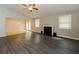 Spacious living room featuring hardwood floors, a fireplace, and a ceiling fan at 8404 Park Ridge Ln, Riverdale, GA 30274
