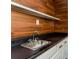 Stylish sink area with unique wooden accents and a sleek, modern design at 8404 Park Ridge Ln, Riverdale, GA 30274