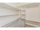 This walk-in closet features built-in shelving and clothing rods for maximum storage at 8404 Park Ridge Ln, Riverdale, GA 30274