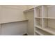 This walk-in closet features built-in shelving and a clothing rod for maximum storage at 8404 Park Ridge Ln, Riverdale, GA 30274