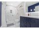 Bathroom featuring a marble tile shower, modern vanity, and stylish fixtures at 860 Peachtree Ne St # 1103, Atlanta, GA 30308