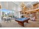 Bright game room with a pool table, fireplace, and ample seating near the large windows at 860 Peachtree Ne St # 1103, Atlanta, GA 30308