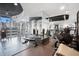 Community gym with mirrored wall, multiple weight machines and city views at 860 Peachtree Ne St # 1103, Atlanta, GA 30308