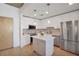 Modern kitchen features white cabinetry, stainless steel appliances and an island at 860 Peachtree Ne St # 1103, Atlanta, GA 30308