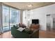 Bright condo featuring comfortable seating, city view and modern lighting fixtures at 860 Peachtree Ne St # 1103, Atlanta, GA 30308
