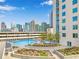 Rooftop pool deck surrounded by landscaping with city views and many lounge chairs at 860 Peachtree Ne St # 1103, Atlanta, GA 30308