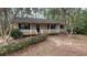 Charming single-story home featuring a cozy front porch nestled among mature trees at 99 Fox Ridge Ct, Dallas, GA 30157