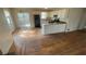 Open kitchen features white cabinets, appliances, and an eat-in bar overlooking the living area at 99 Fox Ridge Ct, Dallas, GA 30157