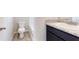 Bathroom featuring a toilet, vanity with sink, granite countertop, and a modern fixtures at 164 Weldon Rd, Mcdonough, GA 30253