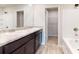 Bathroom featuring double sinks, granite countertops, modern fixtures, and walk in closet at 164 Weldon Rd, Mcdonough, GA 30253