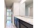 Bathroom featuring double sinks with granite countertops and modern fixtures, with a view into the bedroom area at 164 Weldon Rd, Mcdonough, GA 30253