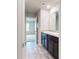 Bathroom showcasing double sinks with granite countertops and modern fixtures, with a view into the bedroom at 164 Weldon Rd, Mcdonough, GA 30253
