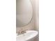 Bathroom featuring modern sink and fixtures with a round mirror at 164 Weldon Rd, Mcdonough, GA 30253