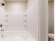 Bathroom with white tub and modern fixtures, surrounded by stylish tiled walls at 164 Weldon Rd, Mcdonough, GA 30253