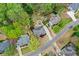 An aerial view showcases this home nestled among mature trees in a quiet neighborhood at 204 Maple Creek Chase, Woodstock, GA 30188