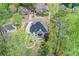 This aerial shot shows the house with a screened porch and lush, mature trees surrounding it at 204 Maple Creek Chase, Woodstock, GA 30188