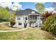 Beautiful backyard with a screened porch, white trim, a well-maintained lawn, and manicured landscaping at 204 Maple Creek Chase, Woodstock, GA 30188