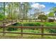 Beautiful backyard with a bridge, mature trees, and lush landscaping at 204 Maple Creek Chase, Woodstock, GA 30188